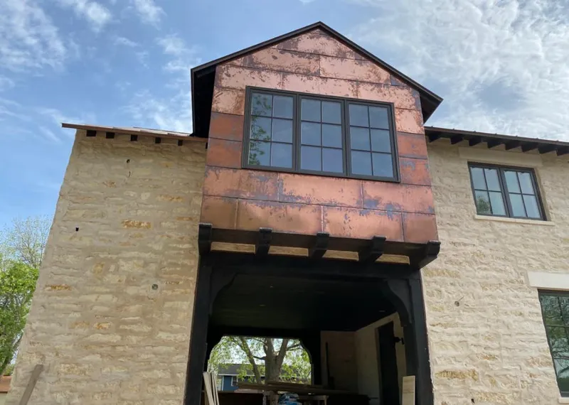 Copper metal panel facade on a stone building for Roof Repair in Hilliard